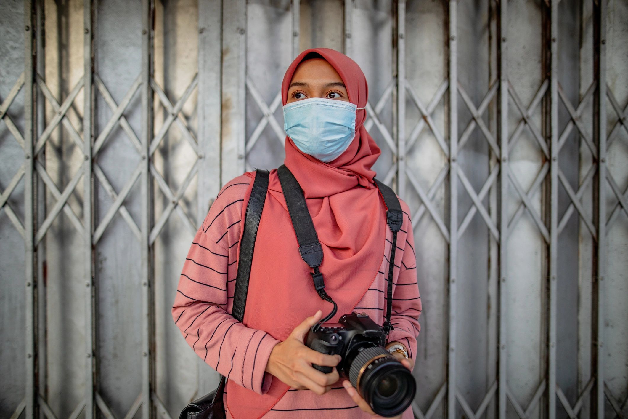 Woman holding a camera representing the photographer