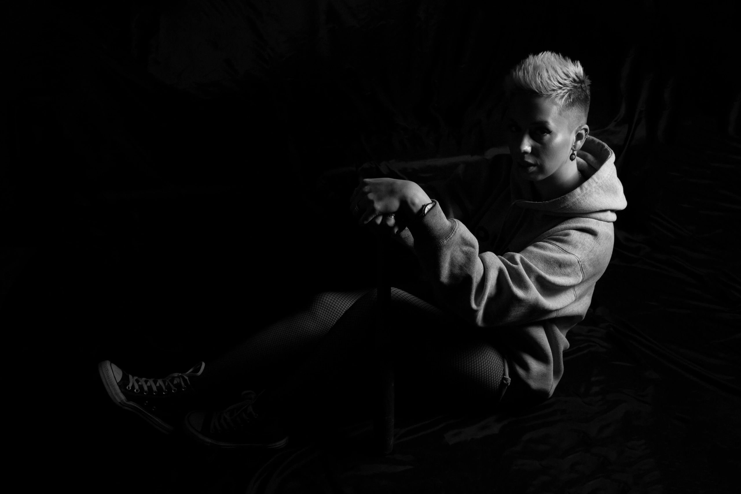 Black and white seated studio portrait