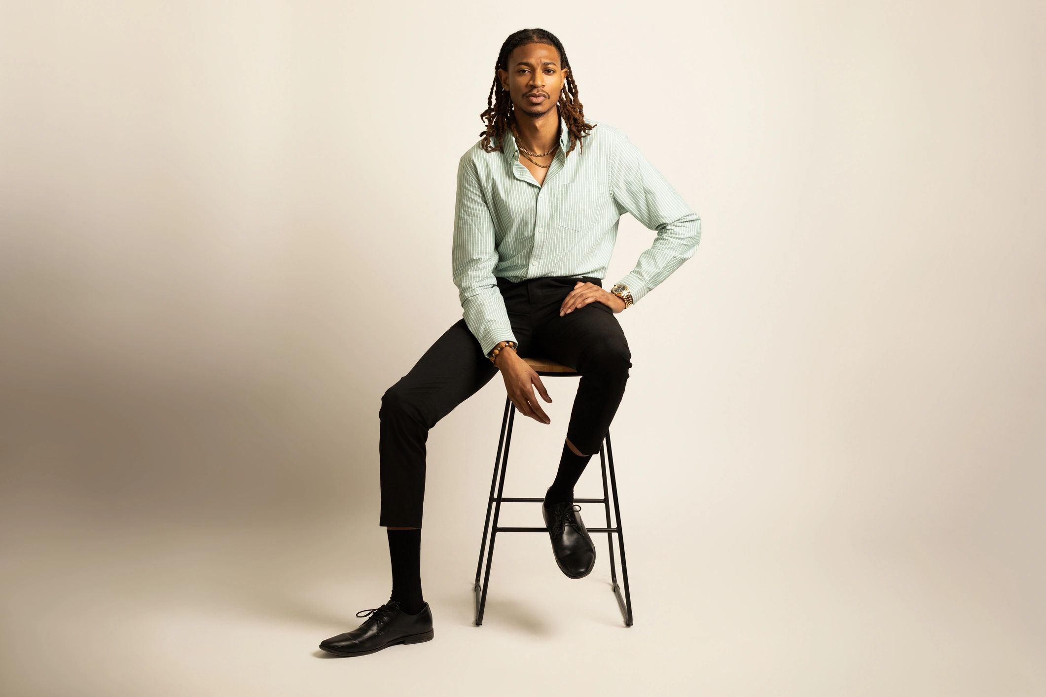Client seated on stool during a studio mini session
