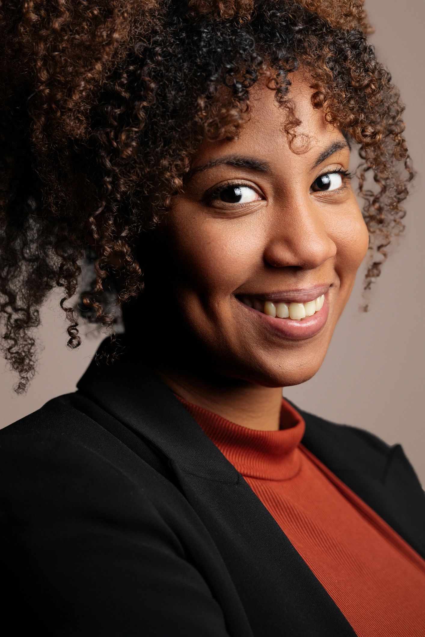 Professional woman smiling confidently in a polished headshot