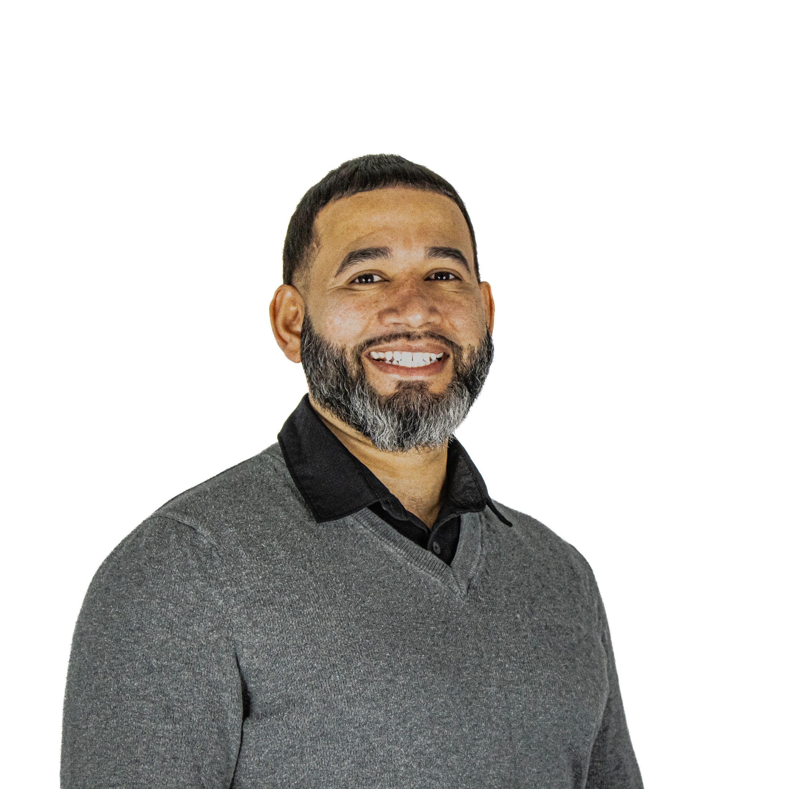 Man smiling at camera in a clean white background headshot